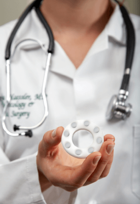 Doctor in Lab Coat Holding the FemPulse Device